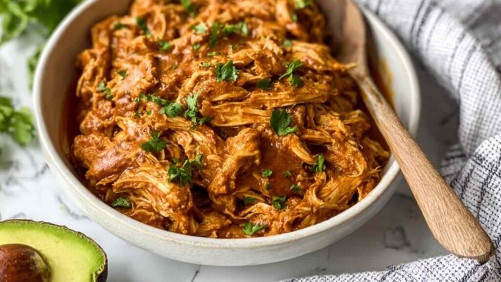 Easy chicken mole recipe served over white rice topped with avocado, sour cream, and fresh cilantro