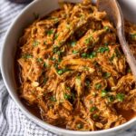 Easy chicken mole recipe served over white rice topped with avocado, sour cream, and fresh cilantro