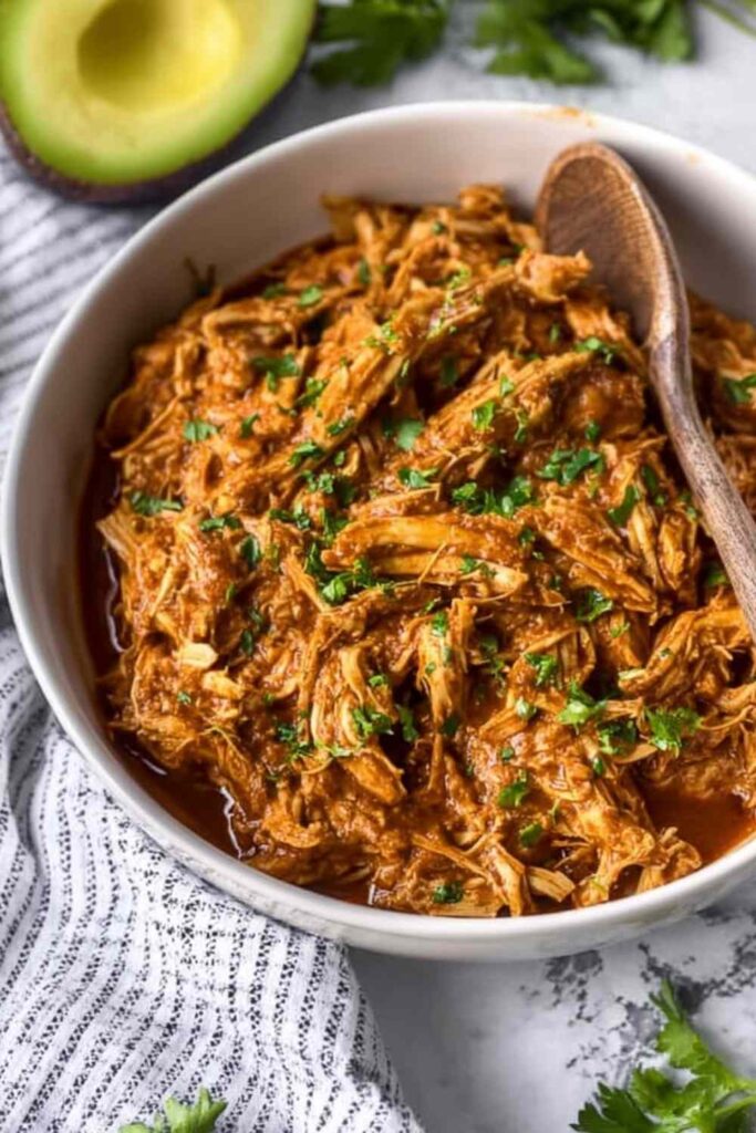 Easy chicken mole recipe served over white rice topped with avocado, sour cream, and fresh cilantro