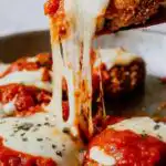 Crispy chicken Parmesan recipe with golden Panko crust, bubbling mozzarella, and marinara sauce in a baking dish