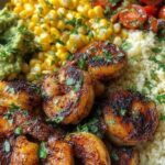 Cilantro lime shrimp bowl with rice, avocado, black beans, corn and cherry tomatoes