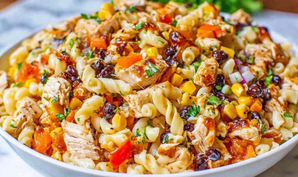 BBQ Chicken Pasta Salad 5 BBQ chicken pasta salad with black beans, corn, and rotini in a large white bowl