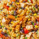 BBQ chicken pasta salad with black beans, corn, and rotini in a large white bowl