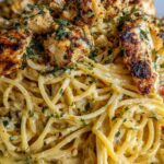 Creamy Cajun chicken spaghetti in a skillet with garlic cream sauce and fresh parsley