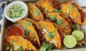 Crispy Baked Tacos Crispy baked tacos on a baking sheet fresh from the oven, golden and filled with seasoned ground beef and melted cheese