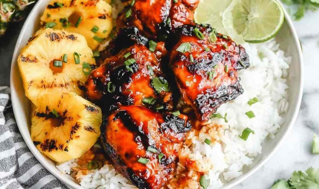 Grilled huli huli chicken recipe served with grilled pineapple and green onion garnish on a plate