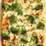 Healthy chicken and broccoli lasagna slice on a white plate with golden melted mozzarella