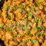 High protein chicken fajita pasta in a skillet with colorful bell peppers and creamy Greek yogurt sauce
