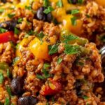 High protein unstuffed peppers in a skillet with melted cheddar cheese and fresh parsley