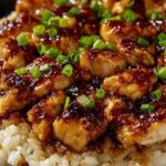 Honey BBQ chicken rice recipe in a skillet garnished with fresh green onions