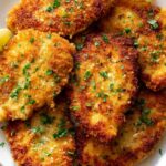 Crispy golden breaded chicken cutlets on a white plate ready to serve
