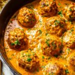 Hungarian paprikash chicken meatballs in silky sour cream paprika sauce served over buttered egg noodles