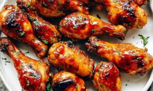 Instant Pot BBQ Chicken Drumsticks with caramelized BBQ glaze on a white serving plate
