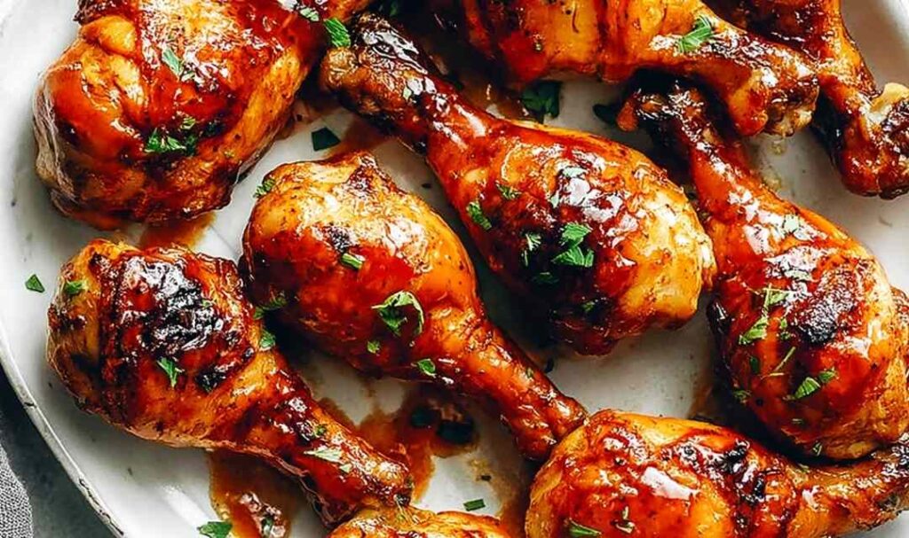 Instant Pot BBQ Chicken Drumsticks with caramelized BBQ glaze on a white serving plate