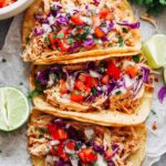 Instant Pot chicken tacos with juicy shredded chicken served in corn tortillas topped with Pico de Gallo and fresh avocado