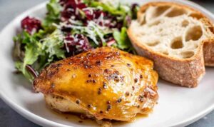 Juicy maple bourbon chicken breasts with a sticky caramelized glaze on a white plate