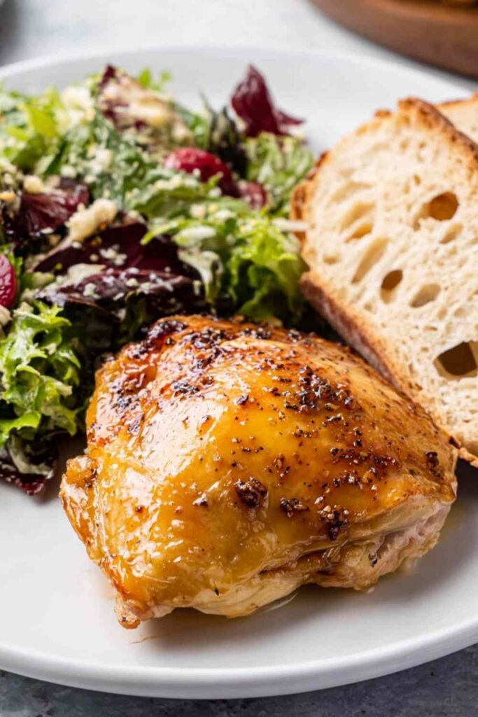 Juicy maple bourbon chicken breasts with a sticky caramelized glaze on a white plate