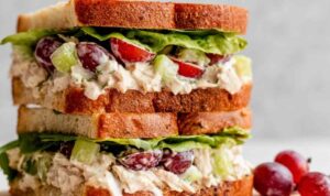 Napa almond chicken salad Panera copycat served on toasted sourdough with fresh lettuce and Roma tomato slices