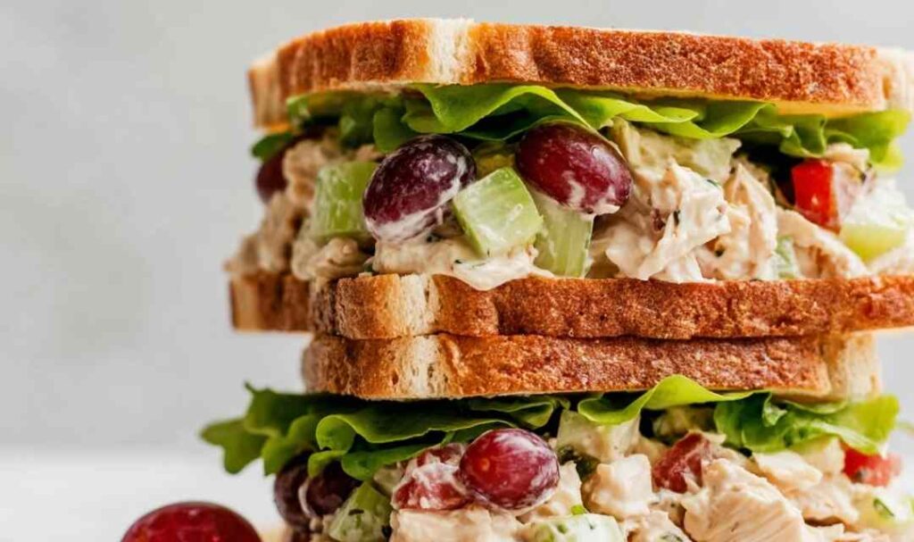 Napa almond chicken salad Panera copycat served on toasted sourdough with fresh lettuce and Roma tomato slices