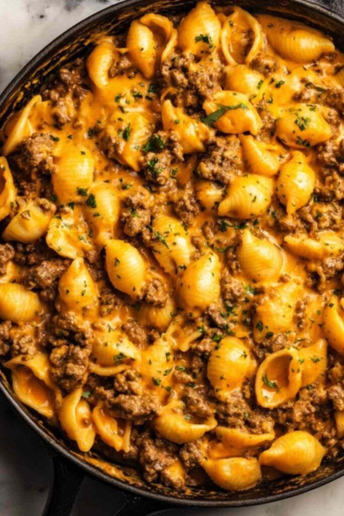 One-Pot Beef and Cheddar Ranch Pasta 6 One-Pot Beef and Cheddar Ranch Pasta in a Dutch oven with creamy cheddar sauce and fresh chive garnish