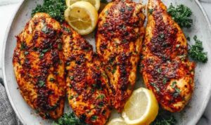 Pan seared chicken breast with golden crust in a cast iron skillet with white wine pan sauce