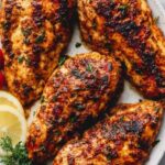 Pan seared chicken breast with golden crust in a cast iron skillet with white wine pan sauce