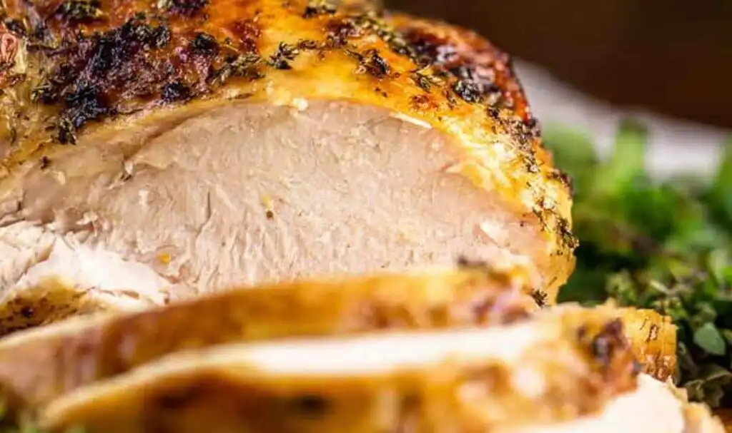 Carved air fryer whole chicken sliced on a serving platter showing juicy tender white and dark meat