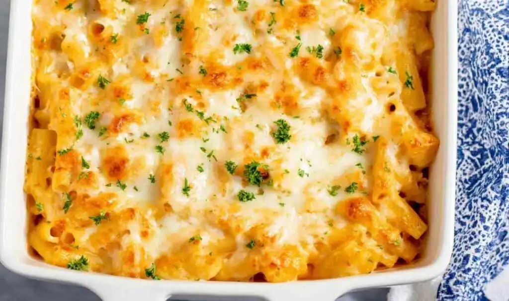 Buffalo Chicken Baked Ziti 5 Buffalo chicken baked ziti in a white 9x13 baking dish with golden melted mozzarella cheese on top