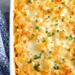 Buffalo chicken baked ziti in a white 9x13 baking dish with golden melted mozzarella cheese on top
