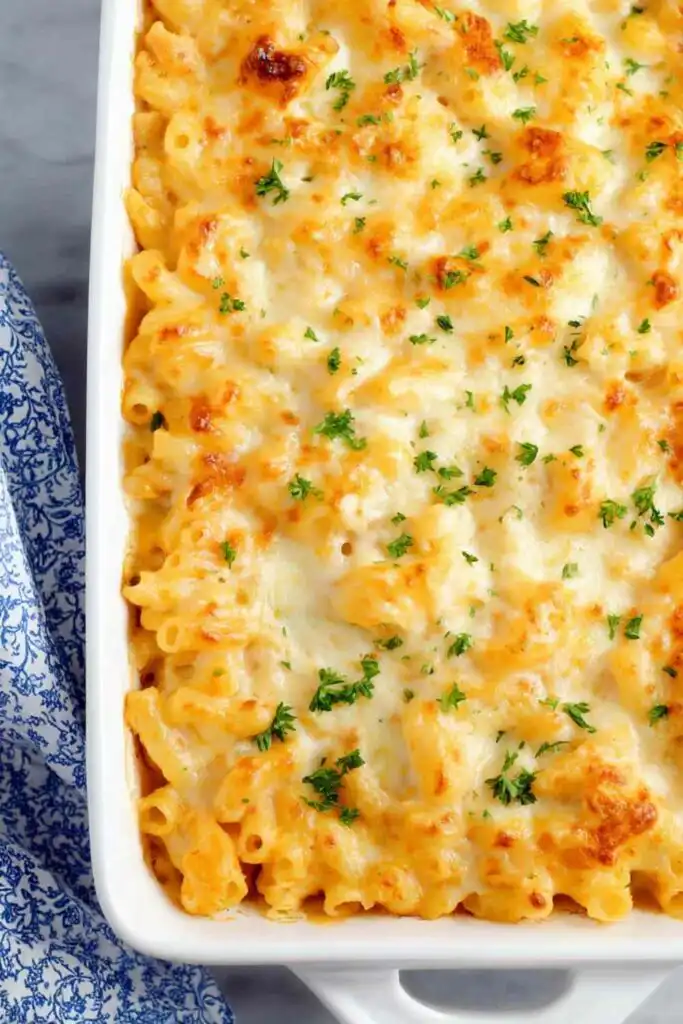 Buffalo Chicken Baked Ziti 6 Buffalo chicken baked ziti in a white 9x13 baking dish with golden melted mozzarella cheese on top