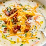 Cheesy chicken chowder recipe in a Dutch oven topped with melted cheddar and fresh parsley