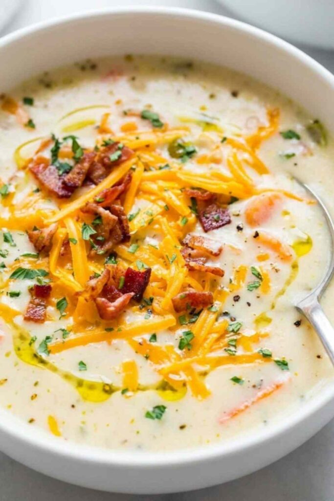 Cheesy chicken chowder recipe in a Dutch oven topped with melted cheddar and fresh parsley