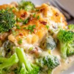 Chicken divan casserole baked golden and bubbly in a white square baking dish