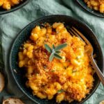 Chicken mac and cheese casserole in a 9x13 baking dish with golden Panko topping and melted cheddar cheese