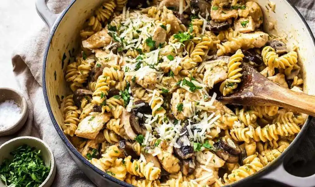 Creamy Chicken Mushroom Pasta (One-Pot) 5 Creamy chicken mushroom pasta in a white bowl topped with fresh parsley and grated Parmesan cheese