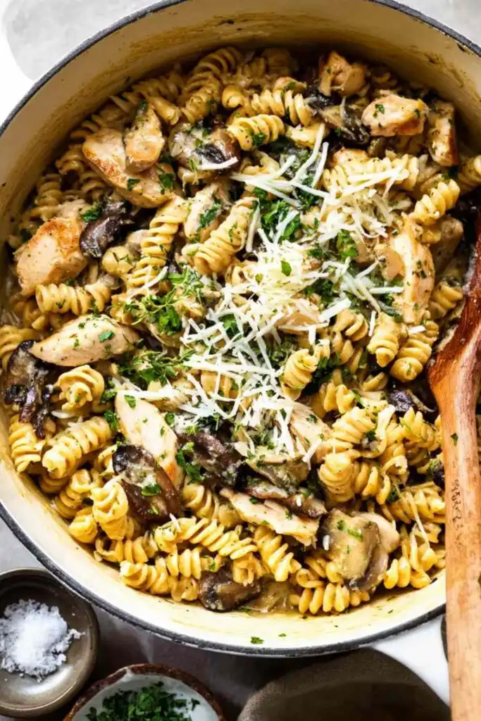 Creamy Chicken Mushroom Pasta (One-Pot) 6 Creamy chicken mushroom pasta in a white bowl topped with fresh parsley and grated Parmesan cheese