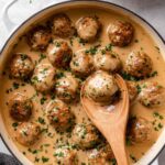 Chicken Swedish meatballs in creamy gravy served over mashed potatoes with fresh parsley garnish