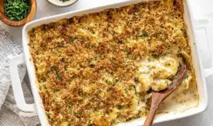 Chicken and stuffing casserole in a white baking dish with golden crispy stuffing topping fresh from the oven