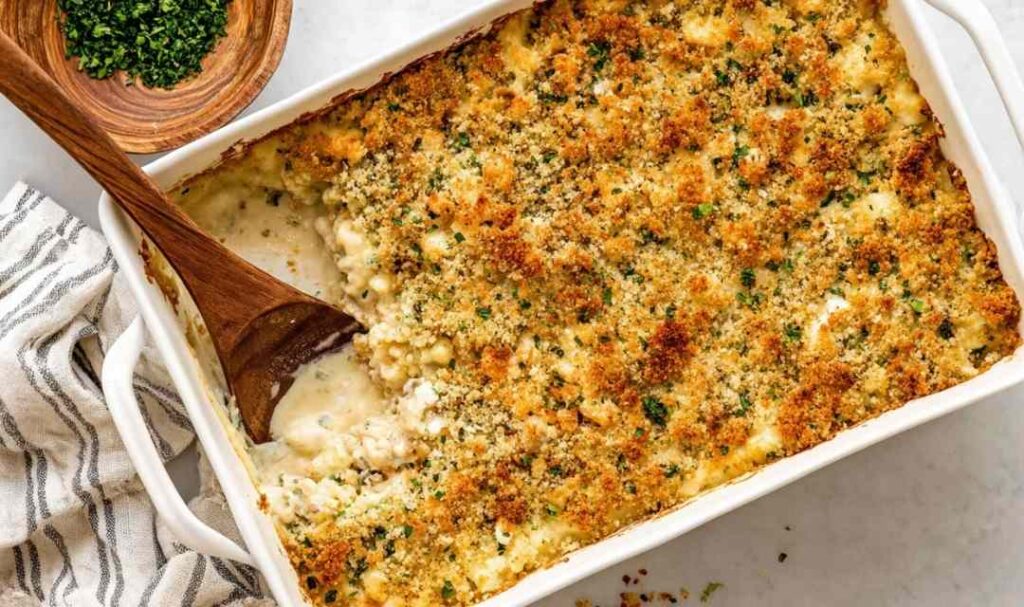 Chicken and Stuffing Casserole 5 Chicken and stuffing casserole in a white baking dish with golden crispy stuffing topping fresh from the oven