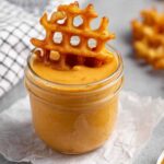 Homemade Chick-Fil-A sauce copycat in a small white bowl surrounded by crispy chicken nuggets