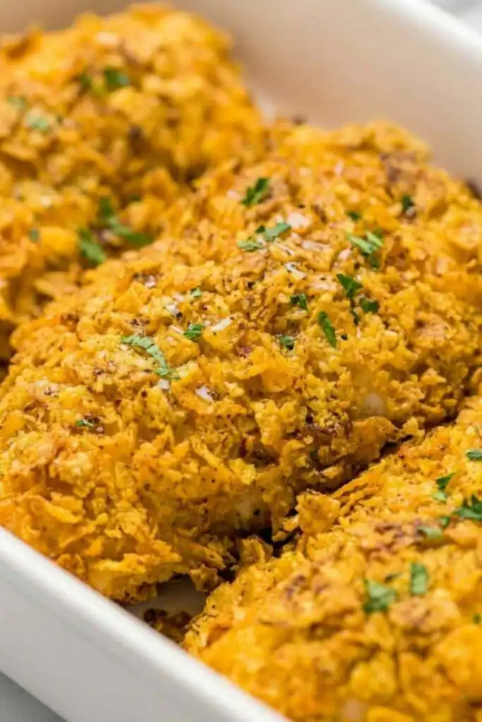 Crispy Cool Ranch Dorito Chicken baked golden in a baking dish with a crunchy Dorito crust