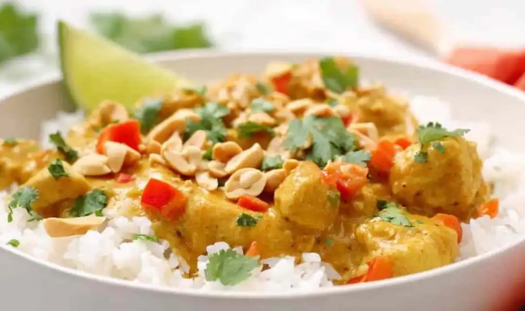 Easy Chicken Curry 5 Easy chicken curry recipe served over basmati rice in a white bowl with fresh cilantro and lime wedges