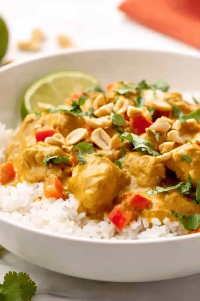 Easy Chicken Curry 6 Easy chicken curry recipe served over basmati rice in a white bowl with fresh cilantro and lime wedges