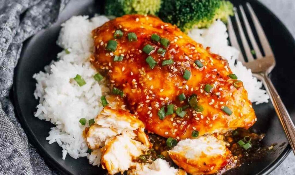 Honey garlic chicken breasts recipe in a skillet coated in sticky soy honey glaze with sesame seeds