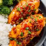 Honey garlic chicken breasts recipe in a skillet coated in sticky soy honey glaze with sesame seeds