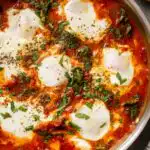 Baked Italian chicken meatballs in oregano marinara sauce topped with melted fresh mozzarella in a skillet