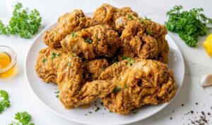 Copycat Kentucky Fried Chicken recipe with golden crispy crust resting on a wire rack