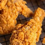 Copycat Kentucky Fried Chicken recipe with golden crispy crust resting on a wire rack