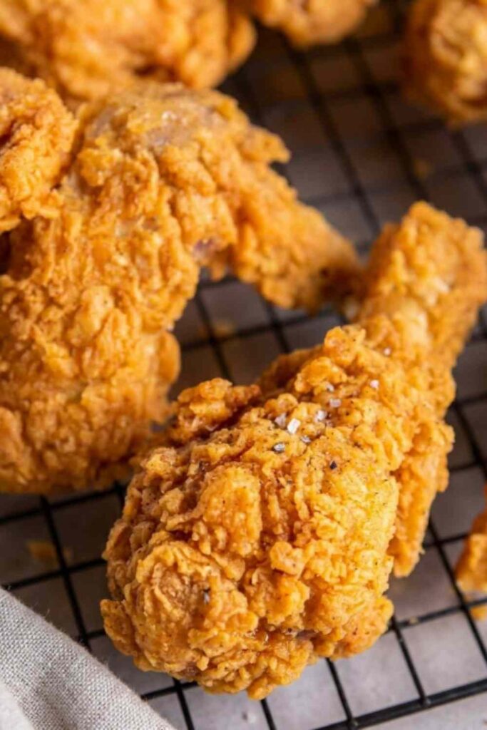 Copycat Kentucky Fried Chicken recipe with golden crispy crust resting on a wire rack