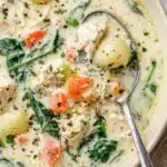 Olive Garden chicken gnocchi soup recipe served in a white bowl with shredded chicken, fresh spinach, and potato gnocchi